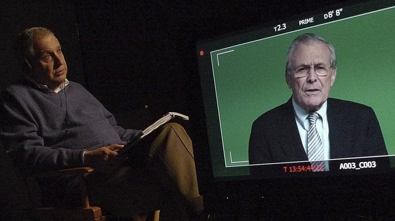 Errol Morris talking to a screen with Donald Rumsfeld on it in The Unknown Known