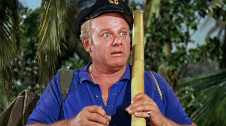 Skipper looking shocked as he stands in shrubbery in Gilligan's Island