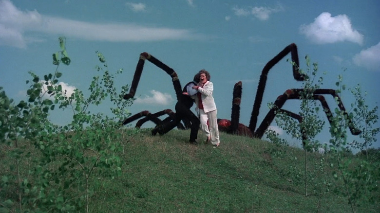 People running away from a giant spider in The Giant Spider Invasion