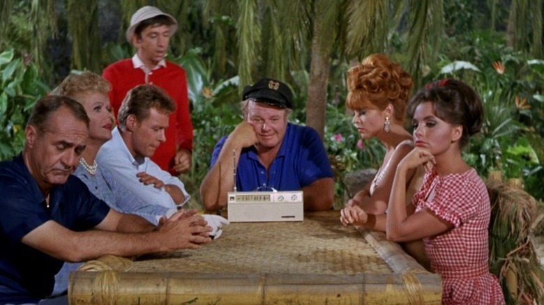 The castaways sitting at a table on Gilligan's Island