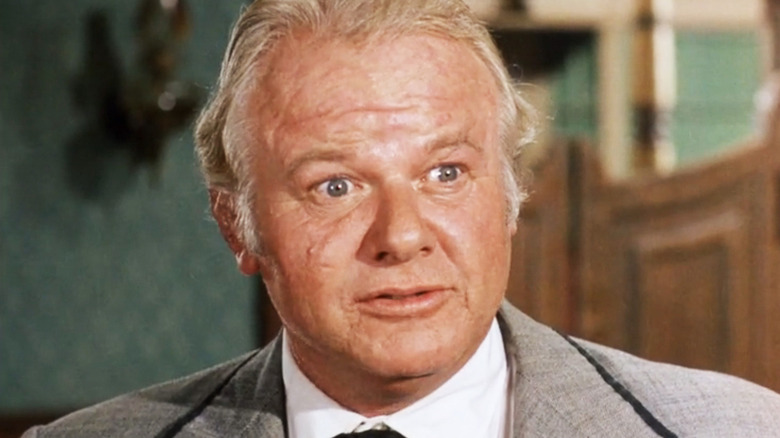 Alan Hale Jr's Bull Bannock is seen in closeup as he stands in a saloon in Gunsmoke