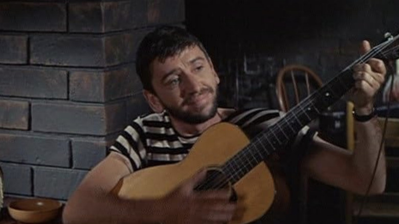 Bob Denver's coffeehouse singer holds his guitar in Take Her, She's Mine