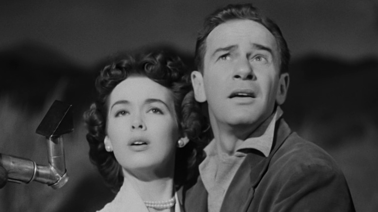 Barbara Rush's Ellen Fields and Richard Carlson's John Putnam look shocked as they stare upwards in It Came from Outer Space