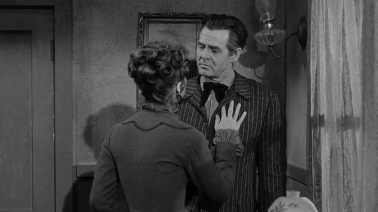 Tina Louise's Helen Crane puts her hand on the chest of Robert Ryan's Blaise Starrett in Day of the Outlaw