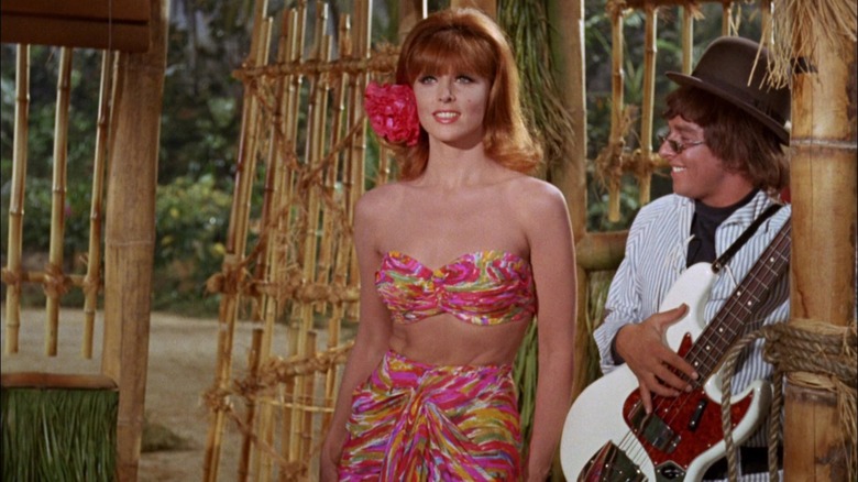 Ginger next to a groovy guitarist on Gilligan's Island