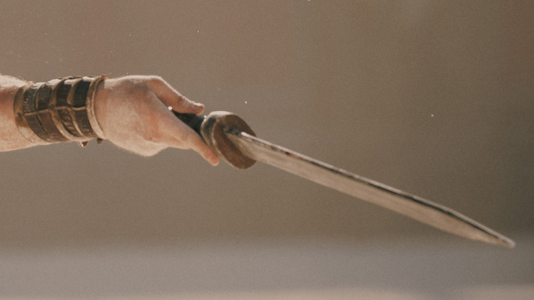 Lucius holds his sword in the arena in Gladiator II