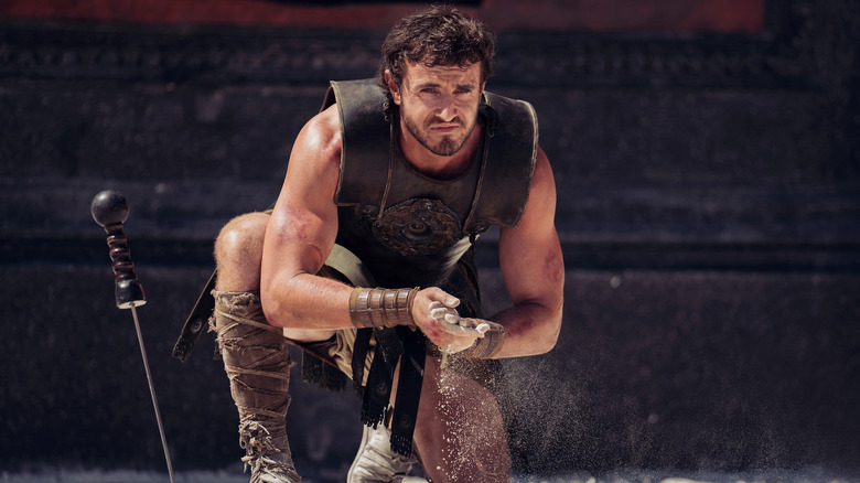 Lucius (Paul Mescal) picks up some sand in Gladiator 2