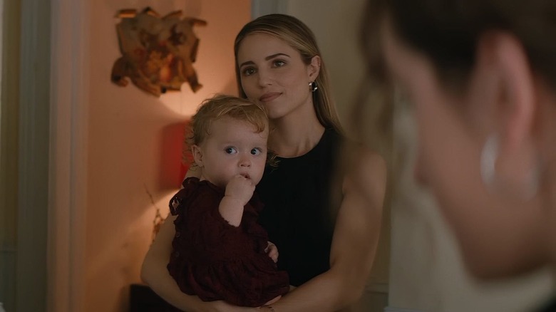 Dianna Agron as Kim, holding a baby in Shiva Baby