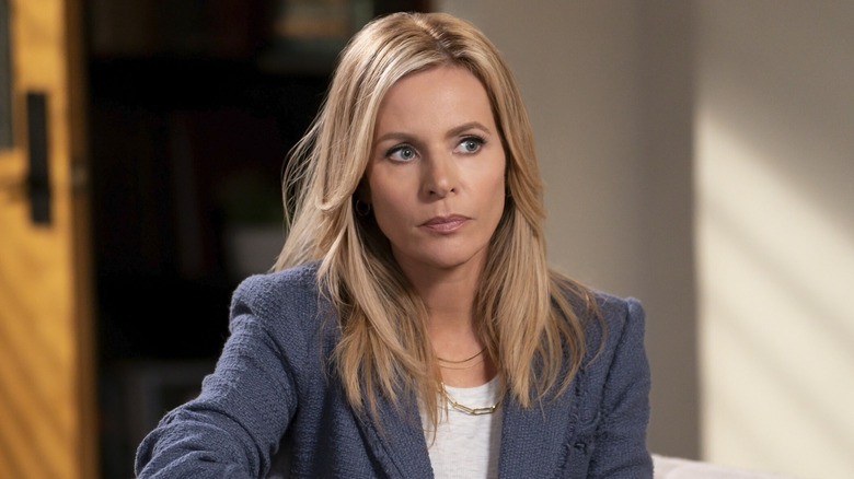 Jessalyn Gilsig as Holly Barrett, sitting in an office in Big Shot