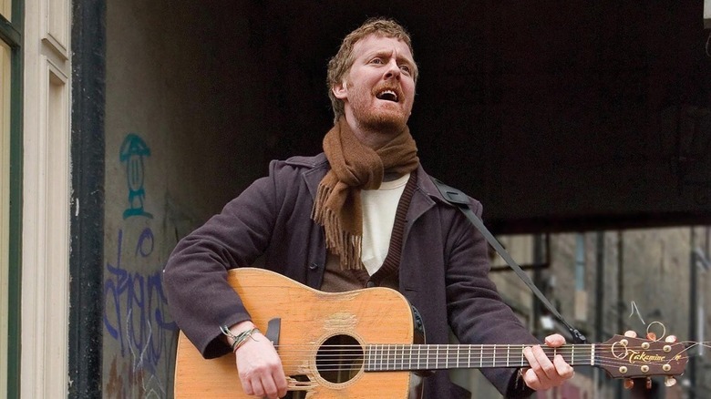 Guy playing a guitar in Once