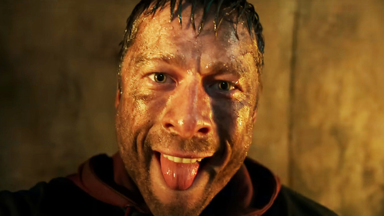 Glen Powell's Ben Richards sticks his tongue out in The Running Man