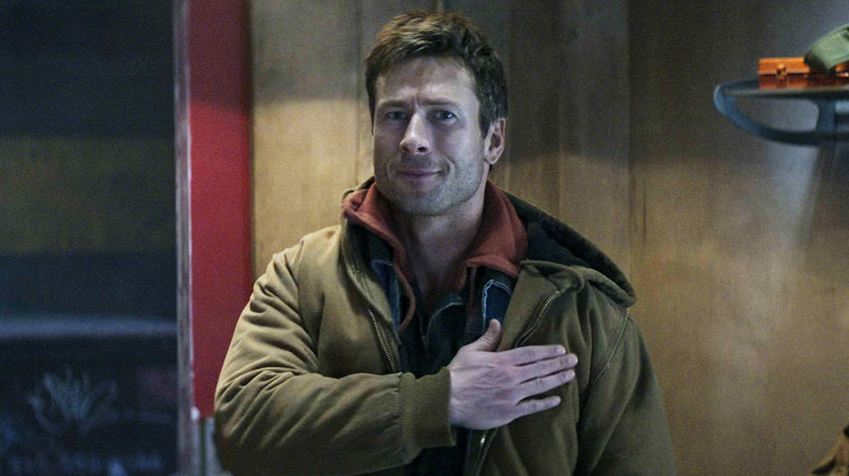 Glen Powell's Ben Richards holds his hand over his heart in The Running Man