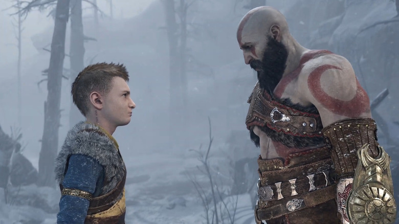 Kratos looking at Atreus in the snow in God of War: Ragnarok