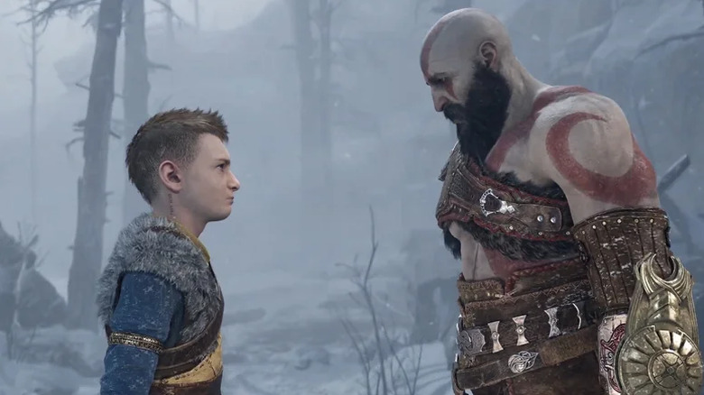 Kratos looking at Atreus in the snow in God of War: Ragnarok