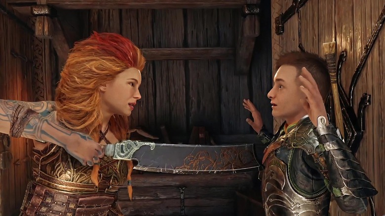 Mina Sundwall as the voice of Thrúd holding a blade at the chest of Sunny Suljic as the voice of Atreus in God of War