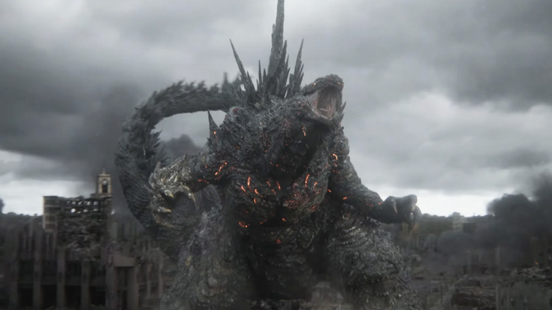 Godzilla roaring above a shattered grey cityscape in Godzilla Minus Zero