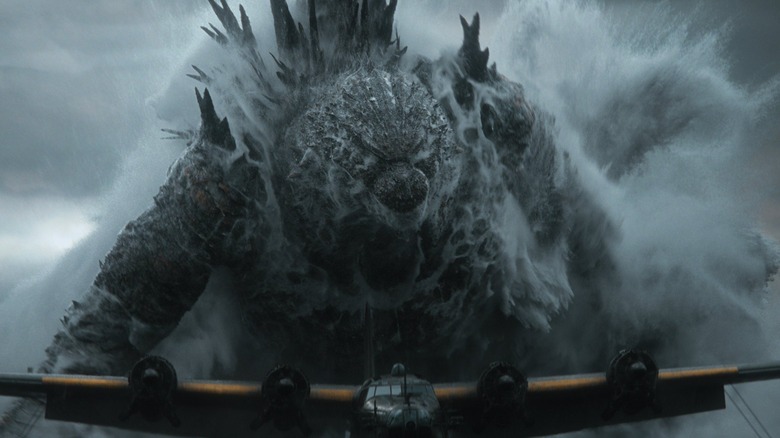 Godzilla as Godzilla emerging from the ocean behind an airplane in Godzilla: Minus Zero