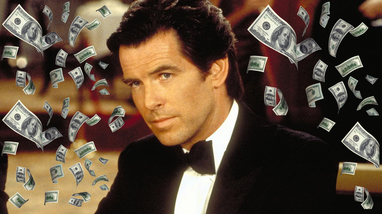 Pierce Brosnan as James Bond sitting at the casino surrounded by money in GoldenEye