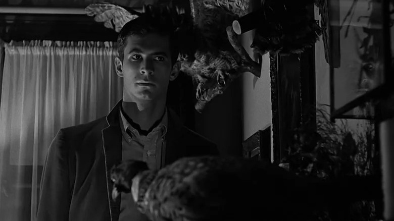 Norman Bates (Anthony Perkins) stares suspiciously in Psycho