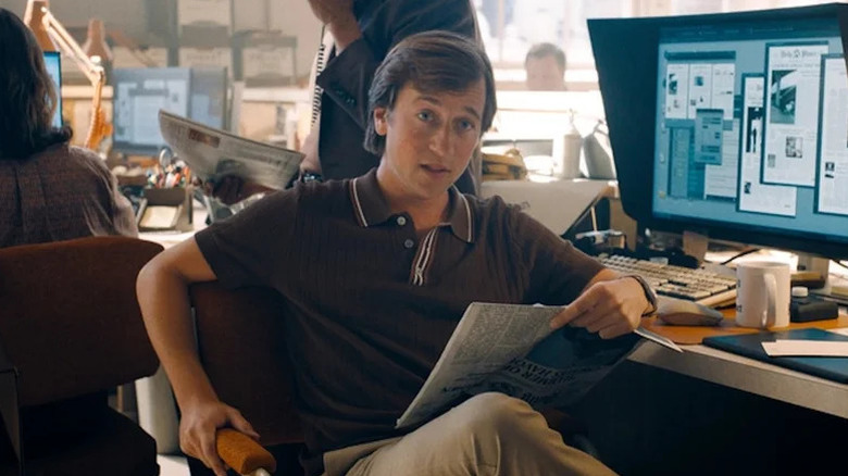 Skyler Gisondo's Jimmy Olsen sits at his desk at the Daily Planet in Superman