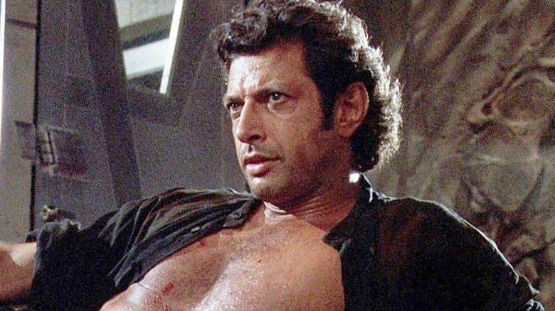 Jeff Goldblum laying with shirt unbuttoned in Jurassic Park