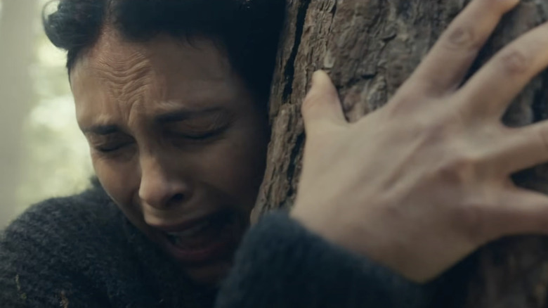 Morena Baccarin as Allison Garrity clinging to a tree in Greenland 2: Migration