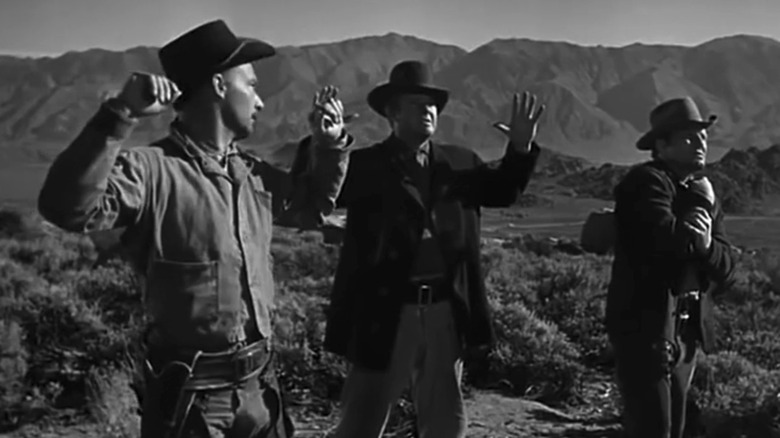 Alan Hale Jr, David Clarke, and John Pickard's brothers stand with their hands in the air in The Gunfighter