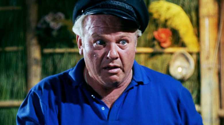 Alan Hale Jr's Captain Jonas Grumby looks surprised as he stands in a shack on Gilligan's Island
