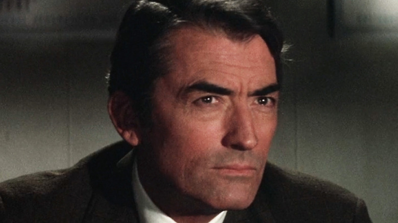 Gregory Peck's Charles Keith looks across frame in closeup in Marooned