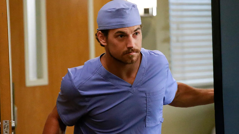 Andrew in a scrub cap standing in a doorway on Grey's Anatomy