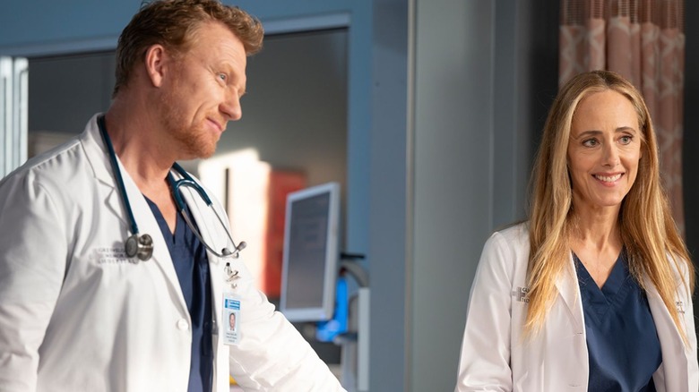 Owen and Teddy by a patient's bed in Grey's Anatomy