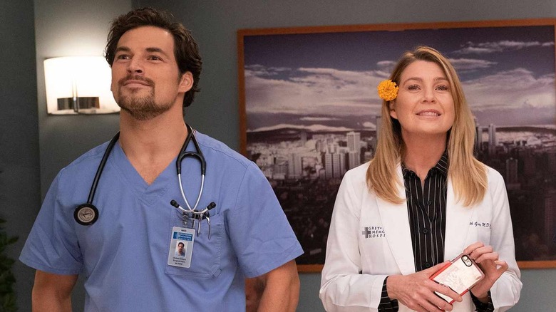 DeLuca and Meredith looking ahead and smiling on Grey's Anatomy