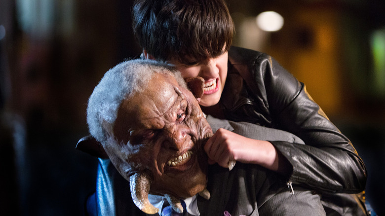 Ron Canada as Stan getting stabbed by Jacqueline Toboni as Trubel in Grimm