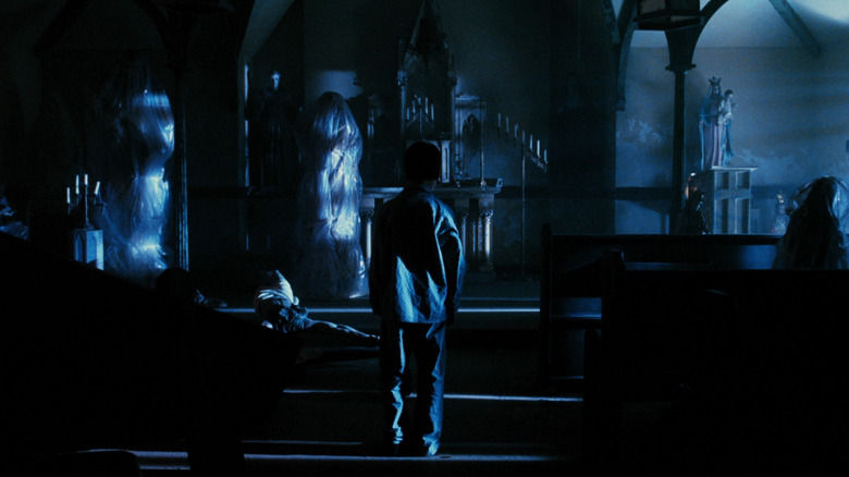 A young boy facing a giant cockroach monster in Mimic