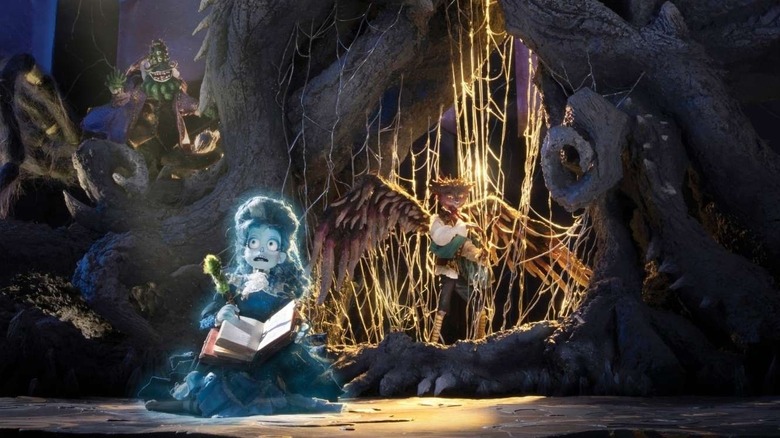 Frankelda writing a story in front of Herneval and the Harpspider