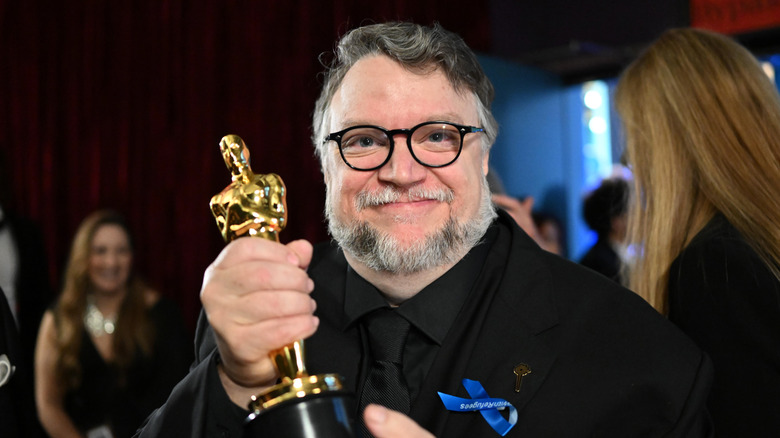 Guillermo Del Toro holding an Oscar