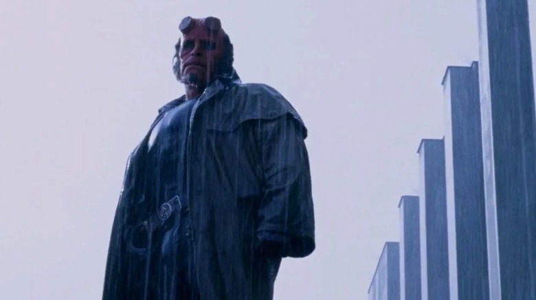 Hellboy (2004) - Hellboy (Ron Perlman) standing in the rain during Professor Broom's funeral