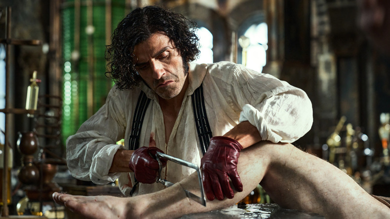 Doctor Victor Frankenstein sawing a leg off a cadaver in Frankenstein