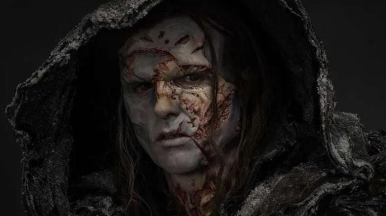 The Creature and his stitched-up face in Frankenstein