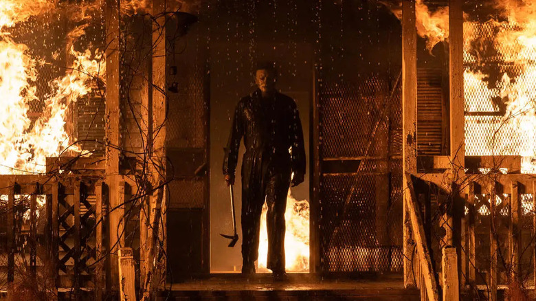 Michael Myers (James Jude Courtney) stands in front of a burning house in Halloween Kills