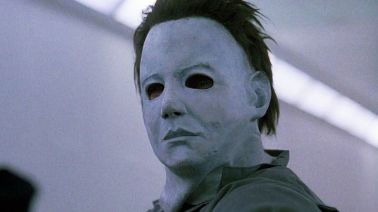 Michael Myers (George P. Wilbur) stands in a well-lit hallway in Halloween: The Curse of Michael Myers