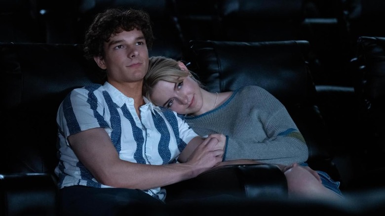 Mason Thames as Miller holding onto McKenna Grace as Clara in a movie theater in Regretting You
