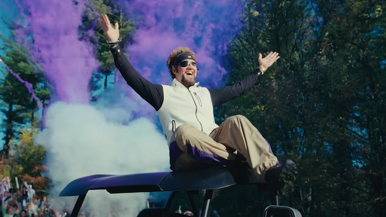 Frank Manatee (Benny Safdie) celebrates on top of a golf cart in Happy Gilmore 2