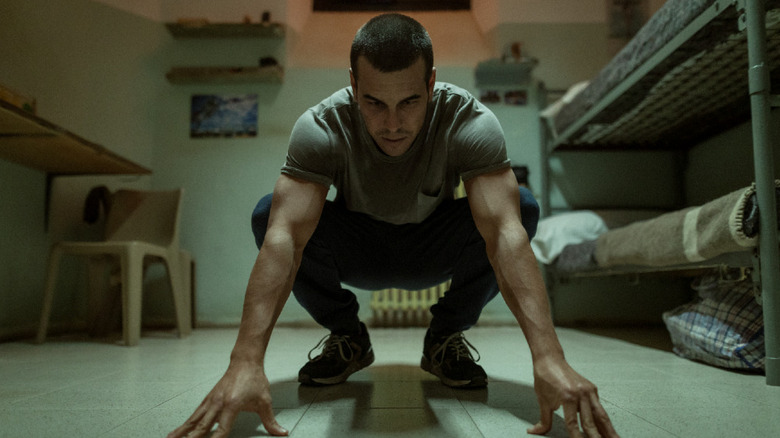 Marios Casas as Mateo Vidal, squatting down in prison on The Innocent