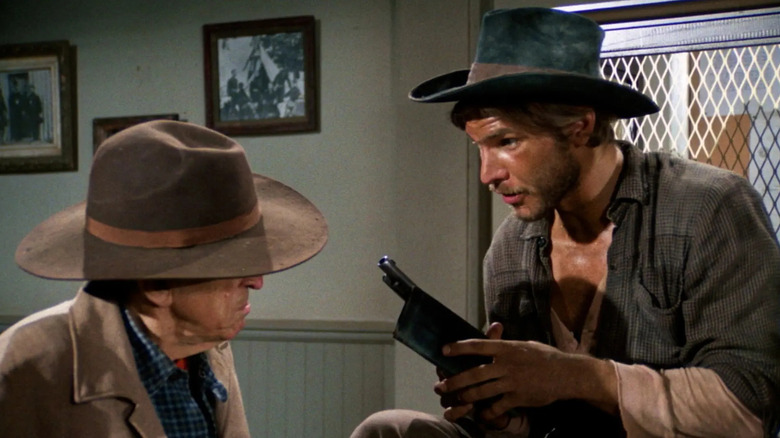 Harrison Ford as Hobey holding a gun on Gunsmoke