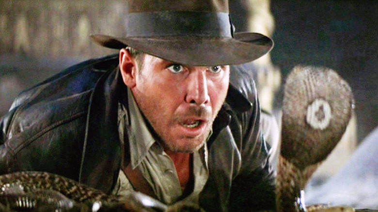 Indiana Jones looking scared at a snake