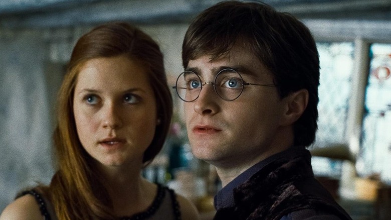 Harry and Ginny looking at something off camera