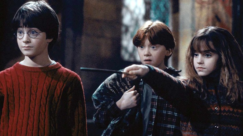 Hermione casting a spell alongside Harry and Ron in Sorcerer's Stone
