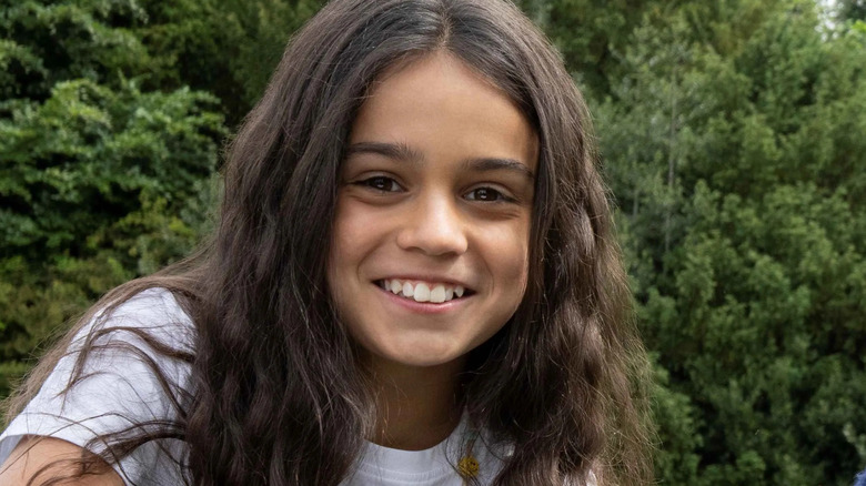 Arabella Stanton smiling against a backdrop full of trees