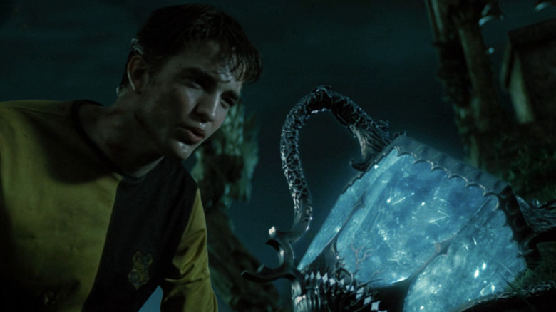 Cedric Diggory (Robert Pattinson) next to a portkey in Harry Potter and the Goblet of Fire